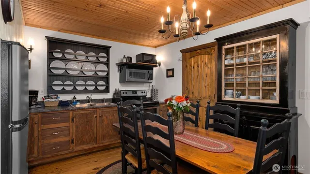 a view of a dining room with furniture and chandelier