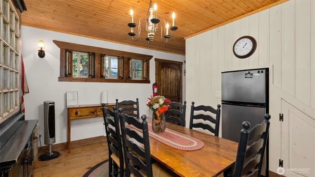 a view of a dining room with furniture and chandelier