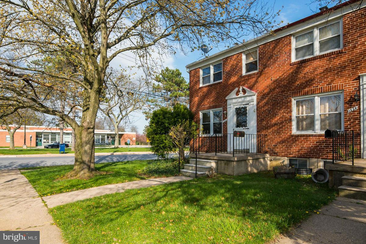 1561 Clairidge Road Baltimore, MD 21207 - Photo 3 of 28 a front view of a house with garden and trees