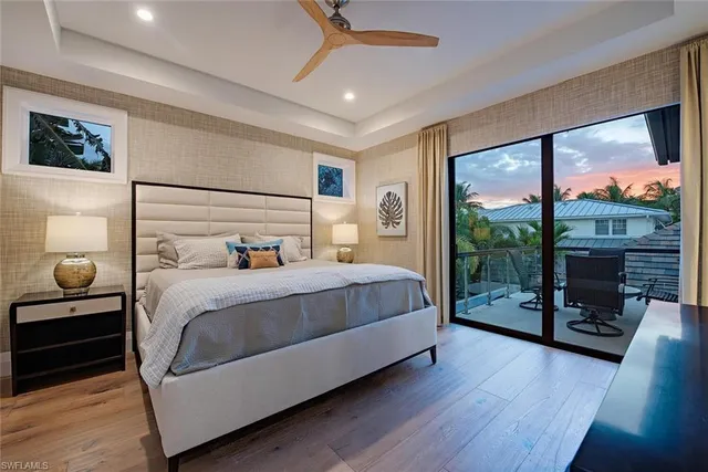 a bathroom with a granite countertop sink toilet a large mirror a shower and a bathtub