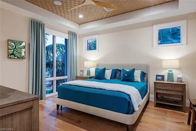 a bedroom with a bed and a large window