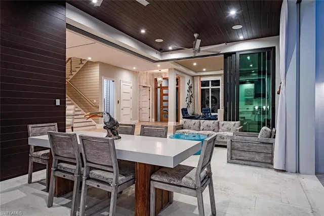 a living room with patio furniture and a floor to ceiling window