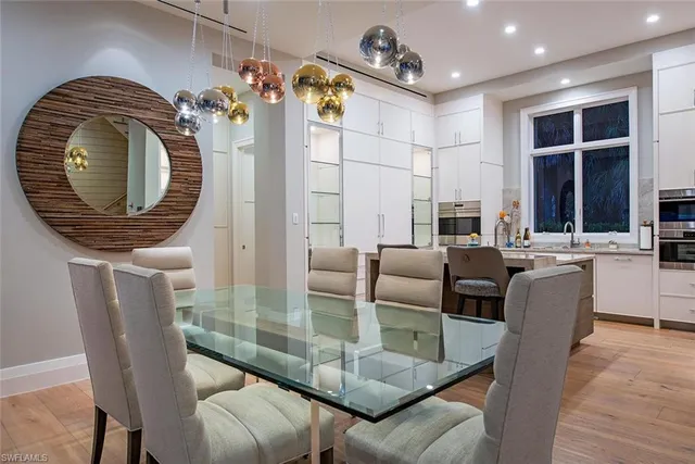 a dining room with furniture and a floor to ceiling window