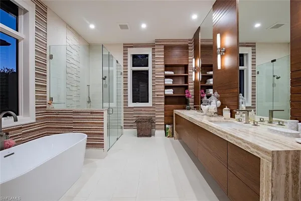 a large bathroom with a large tub and sink