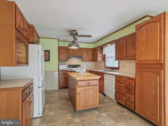 a kitchen with cabinets appliances and a window