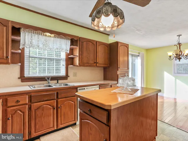a kitchen with a sink cabinets and window
