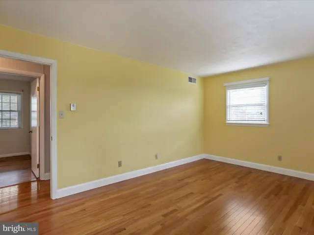 a view of a room with wooden floor and windows