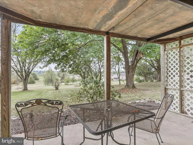 a patio with yard glass top table and chairs