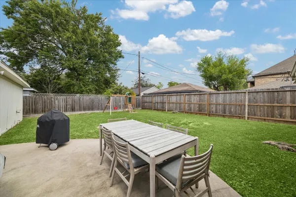 a view of a house with a backyard and a porch