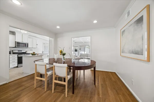 a view of a dining room with furniture and wooden floor