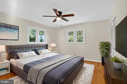 a bedroom with a bed and a potted plant