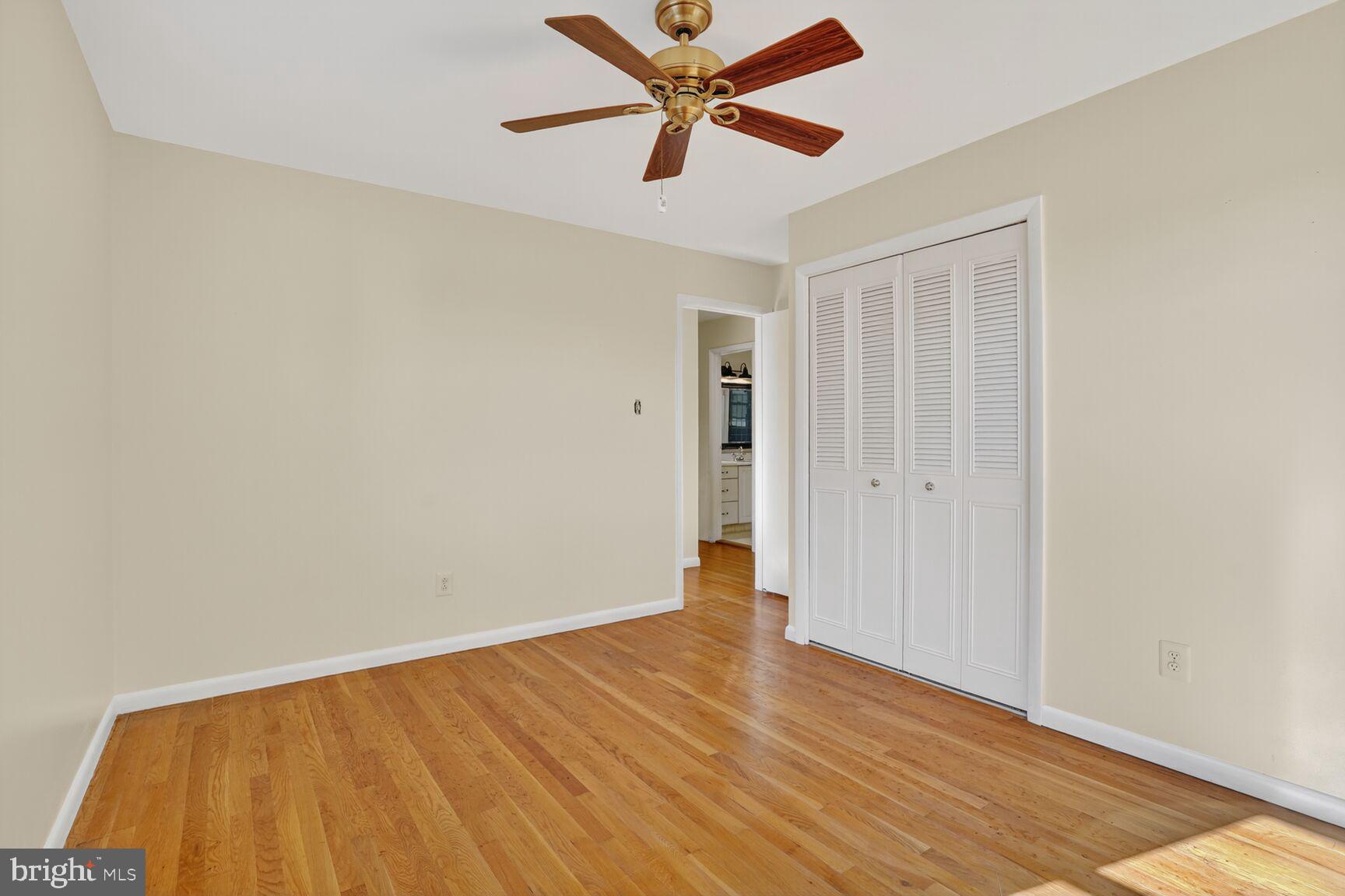 6120 Squire Lane Alexandria, VA 22310 - Photo 15 of 26 an empty room with wooden floor and a ceiling fan