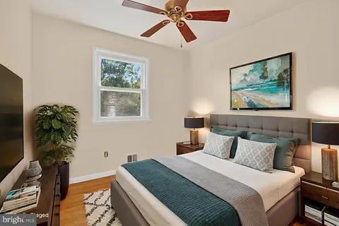 a bedroom with bed and a chandelier