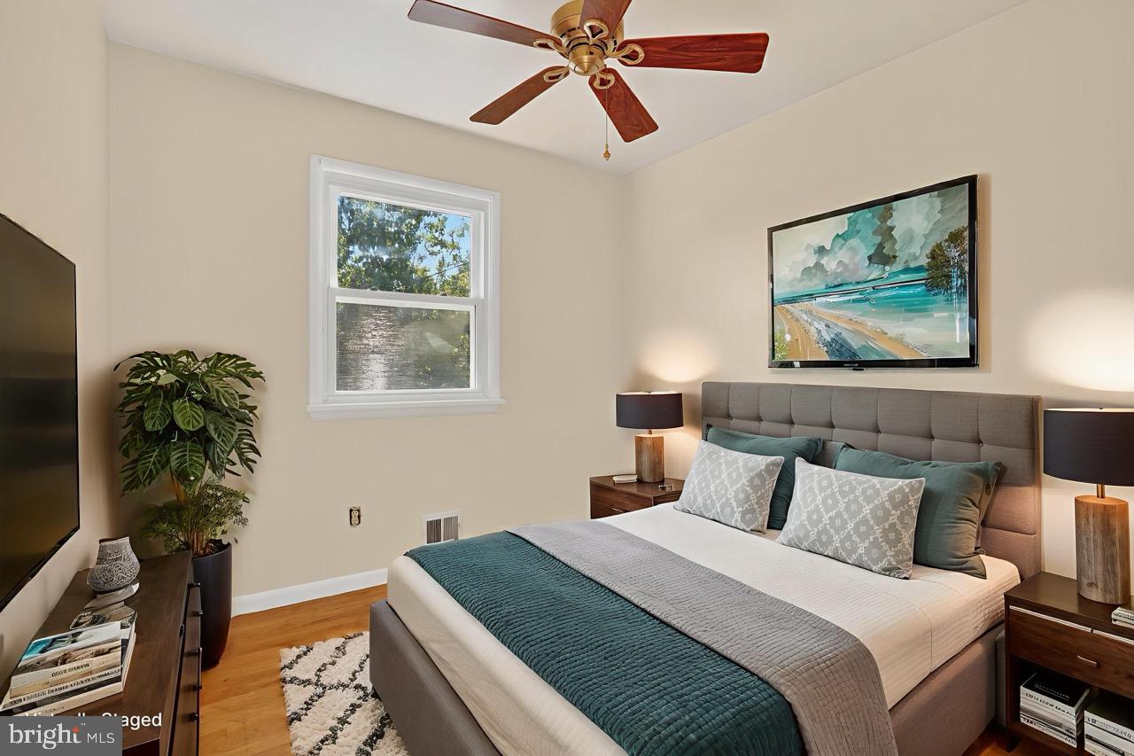 6120 Squire Lane Alexandria, VA 22310 - Photo 16 of 26 a bedroom with bed and a chandelier