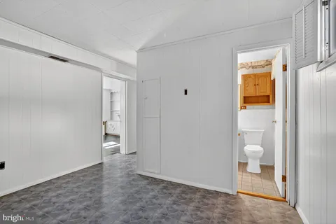 a view of an empty room and a bathroom