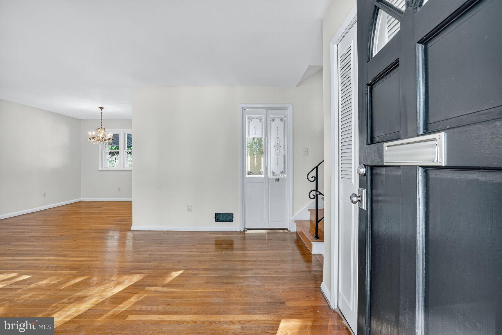 6120 Squire Lane Alexandria, VA 22310 - Photo 3 of 26 an empty room with wooden floor and a hallway