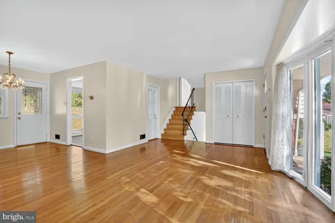 a view of a livingroom with wooden floor and a ceiling fan