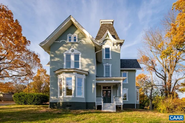 a view of a big house with a small yard and large windows