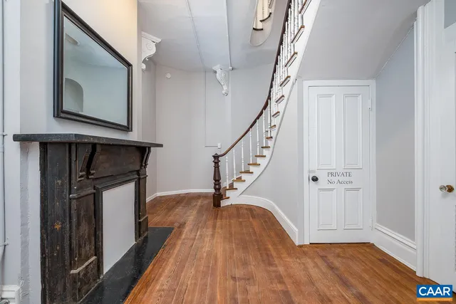 a kitchen with stainless steel appliances kitchen island granite countertop a sink cabinets and wooden floor