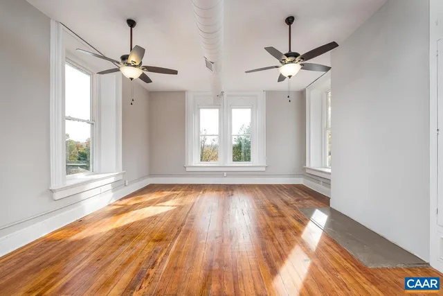 a view of a room with wooden floor