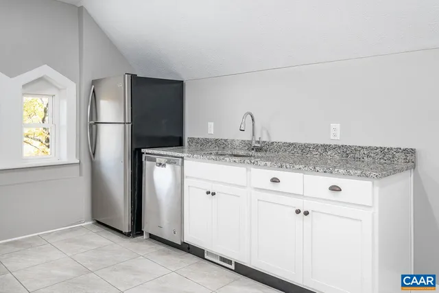 a view of a hallway with wooden floor and entryway