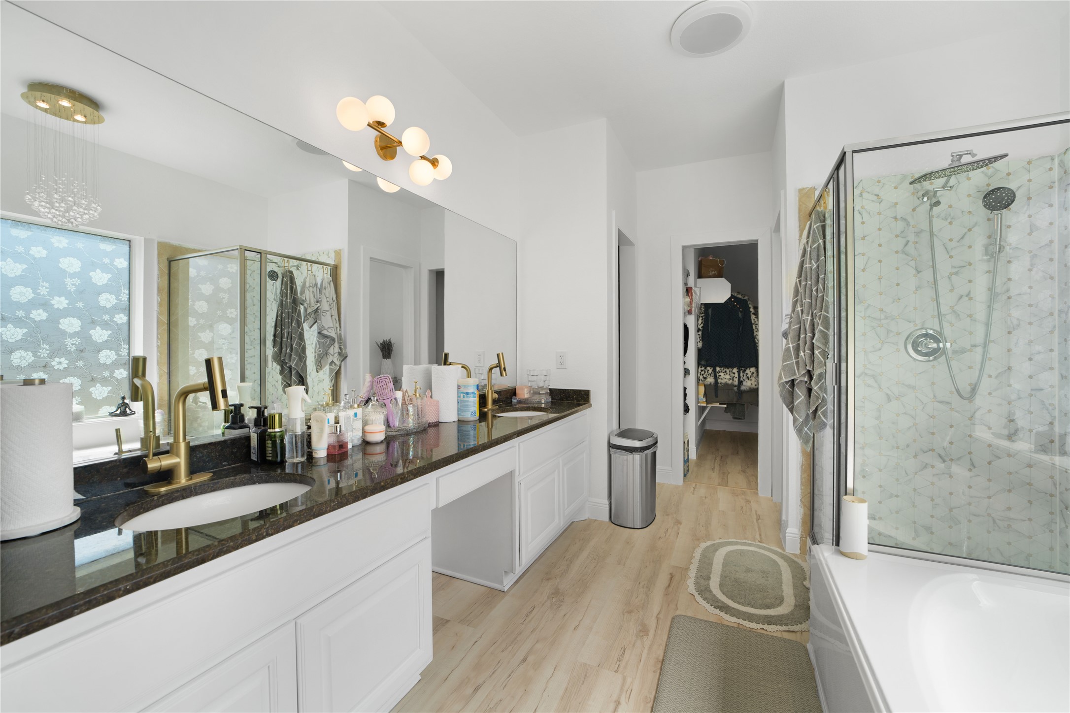 3032 Prairie Bluff Seguin, TX 78155 - Photo 12 of 23 Full bath with a marble finish shower, a garden tub, double vanity, light wood-style flooring, and a spacious closet