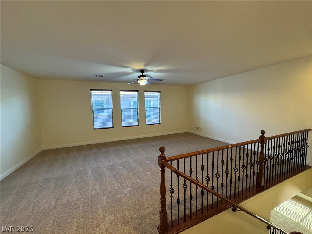 1333 Jamesbury Road Las Vegas, NV 89135 - Photo 25 of 43 A spacious upper-level living area offers comfortable carpeting and natural illumination from multiple windows.