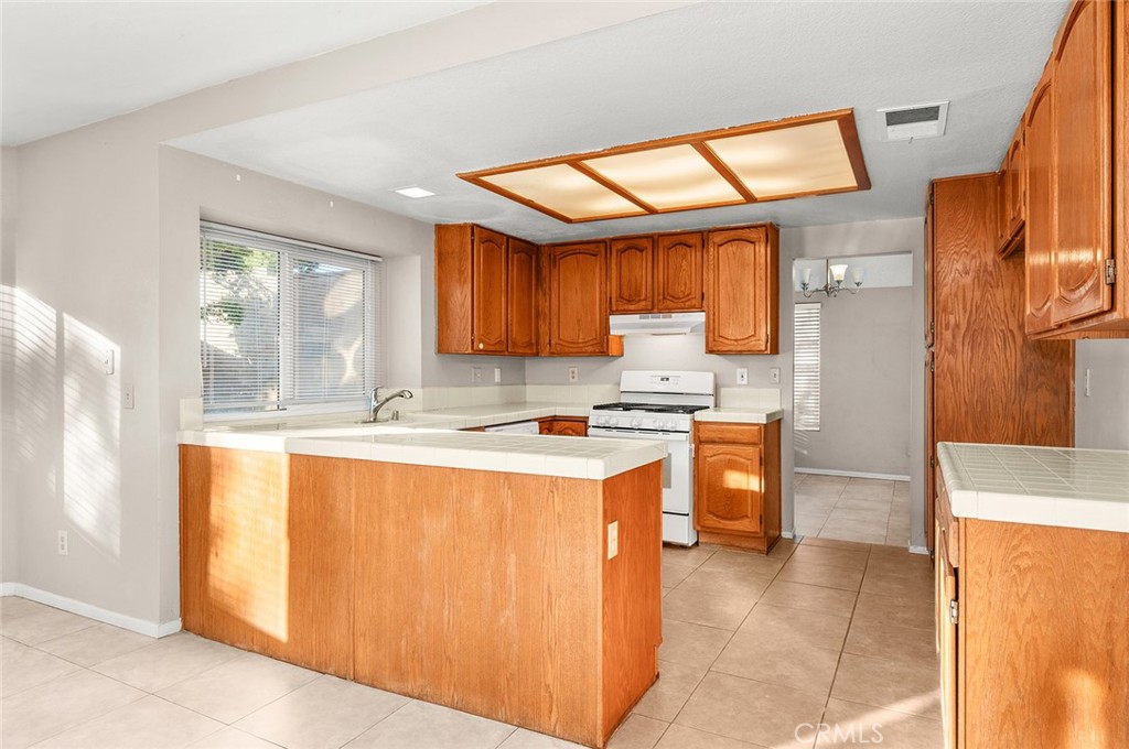 31348 Huron Street Temecula, CA 92592 - Photo 11 of 46 a kitchen with stainless steel appliances granite countertop a stove a sink and a refrigerator