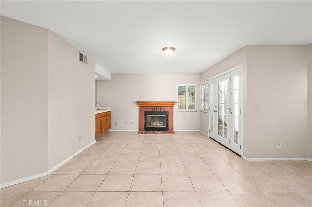 31348 Huron Street Temecula, CA 92592 - Photo 14 of 46 a view of an empty room with a fireplace and a window