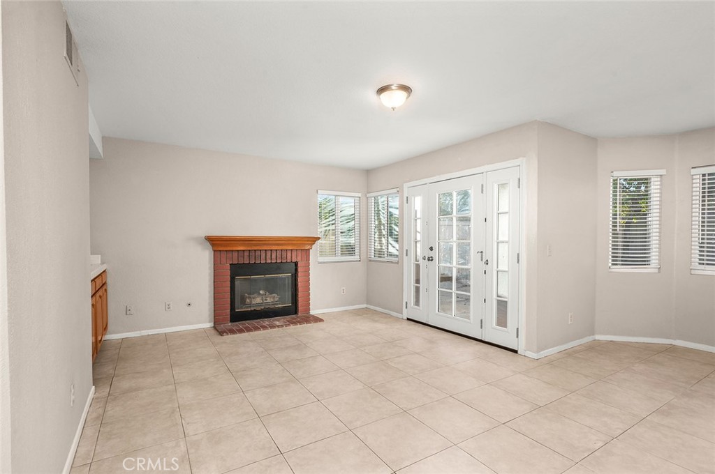 31348 Huron Street Temecula, CA 92592 - Photo 15 of 46 a view of an empty room with a fireplace and a window