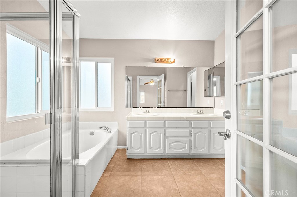 31348 Huron Street Temecula, CA 92592 - Photo 23 of 46 a spacious bathroom with a tub sink and mirror