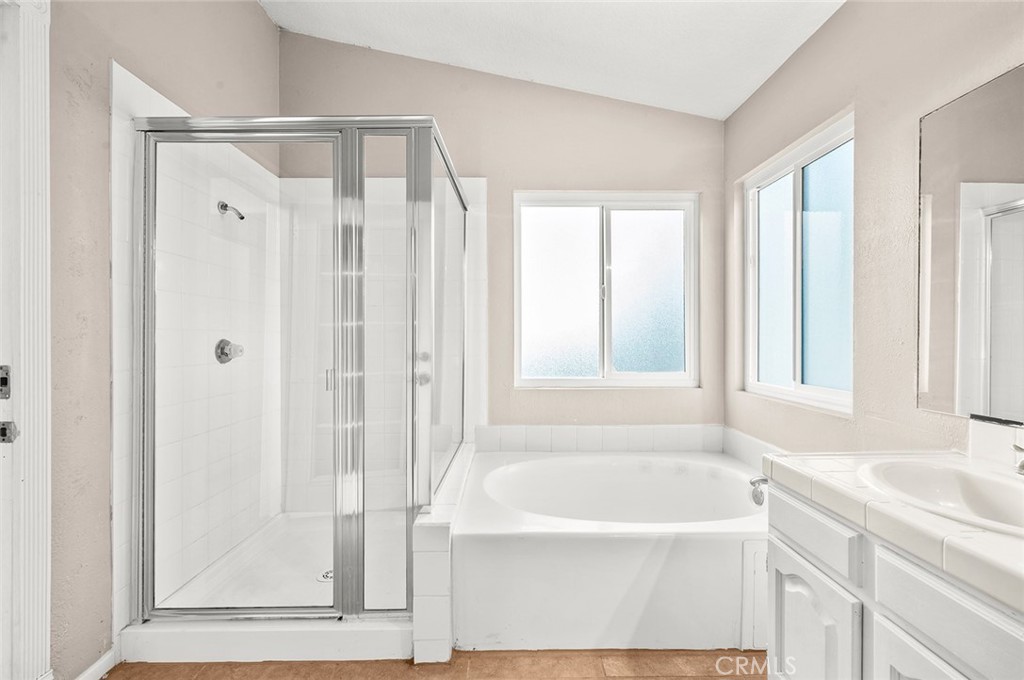31348 Huron Street Temecula, CA 92592 - Photo 24 of 46 a bathroom with a bathtub shower and a sink