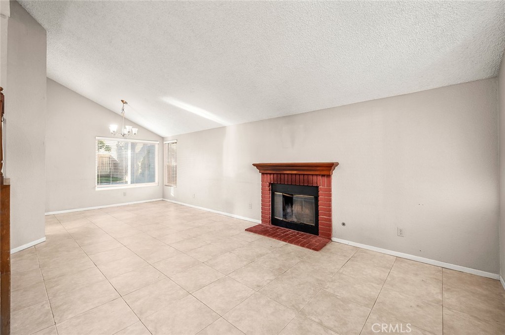 31348 Huron Street Temecula, CA 92592 - Photo 6 of 46 an empty room with a fireplace and windows