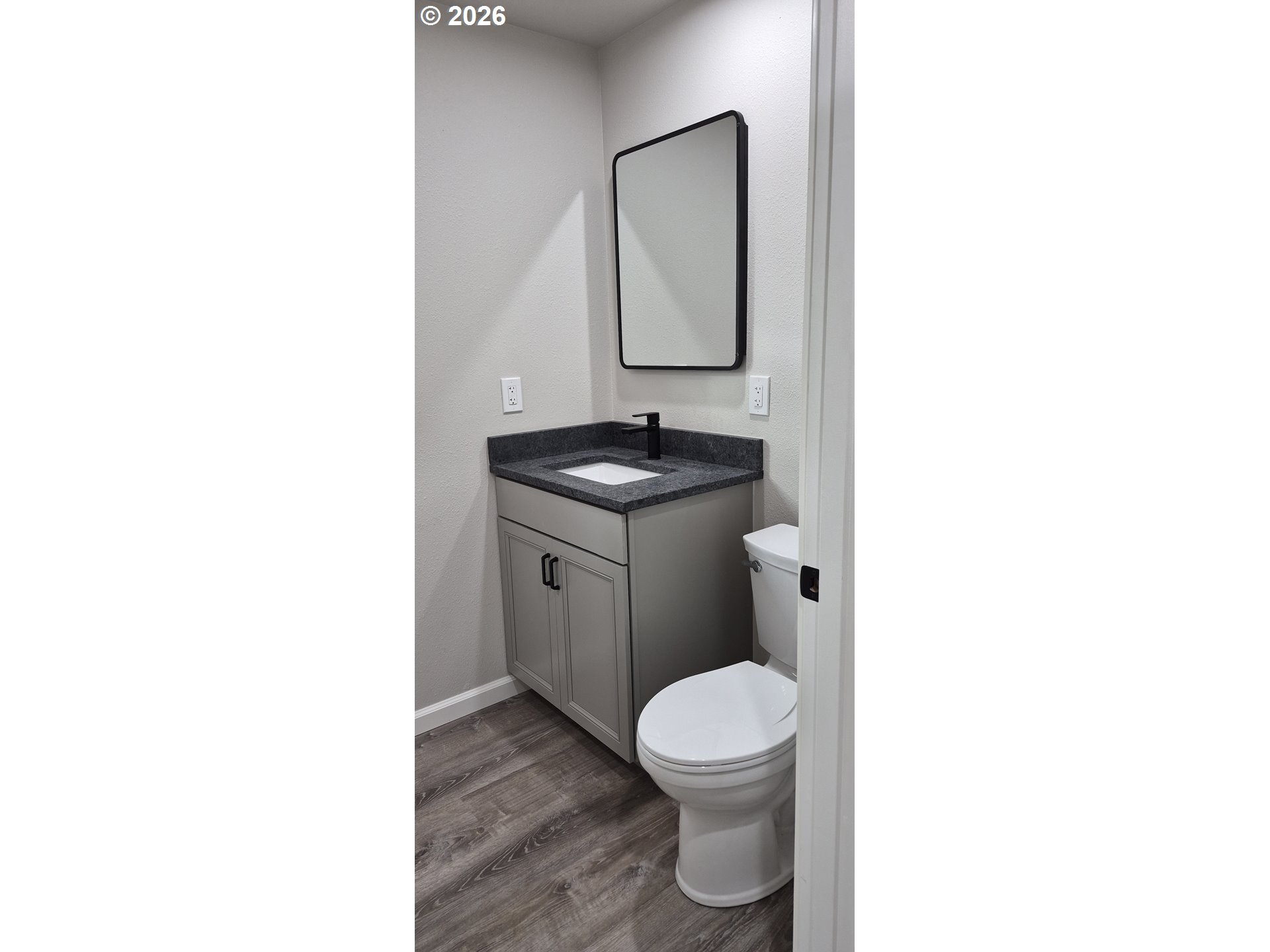 119 Walnut Street Myrtle Creek, OR 97457 - Photo 4 of 10 a bathroom with a toilet sink and mirror