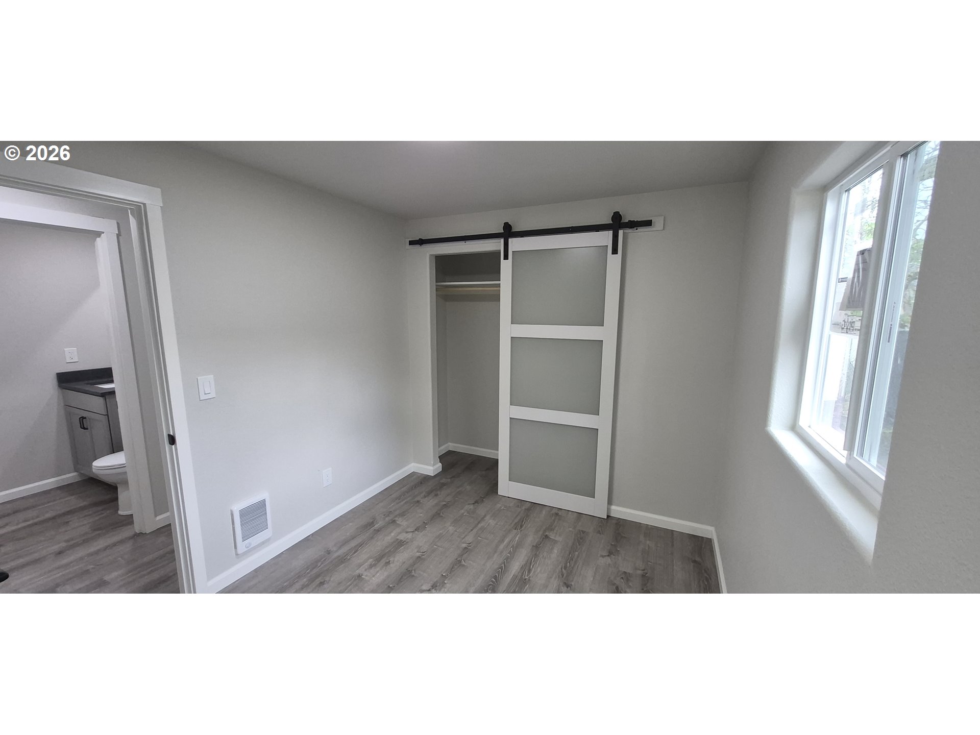 119 Walnut Street Myrtle Creek, OR 97457 - Photo 8 of 10 a view of an empty room with wooden floor and a window