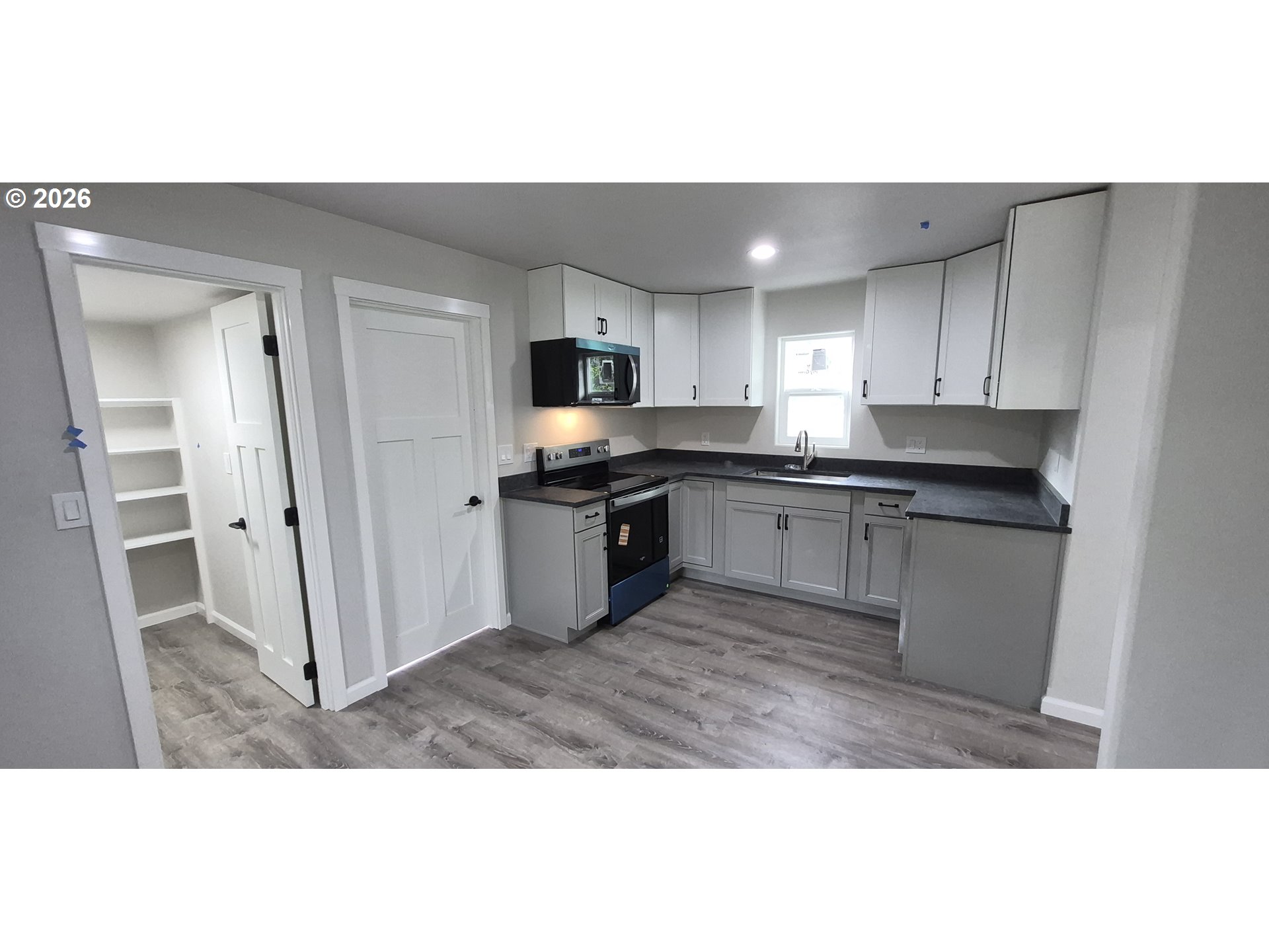 119 Walnut Street Myrtle Creek, OR 97457 - Photo 9 of 10 a kitchen with granite countertop a refrigerator sink and cabinets