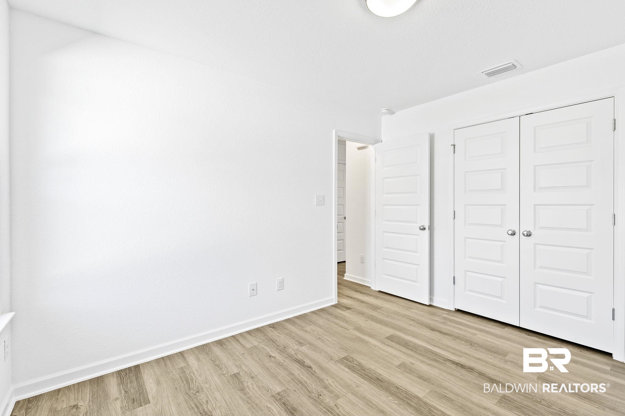 16014 Alabama Avenue Silverhill, AL 36576 - Photo 32 of 50 Unfurnished bedroom with a closet and light hardwood / wood-style floors