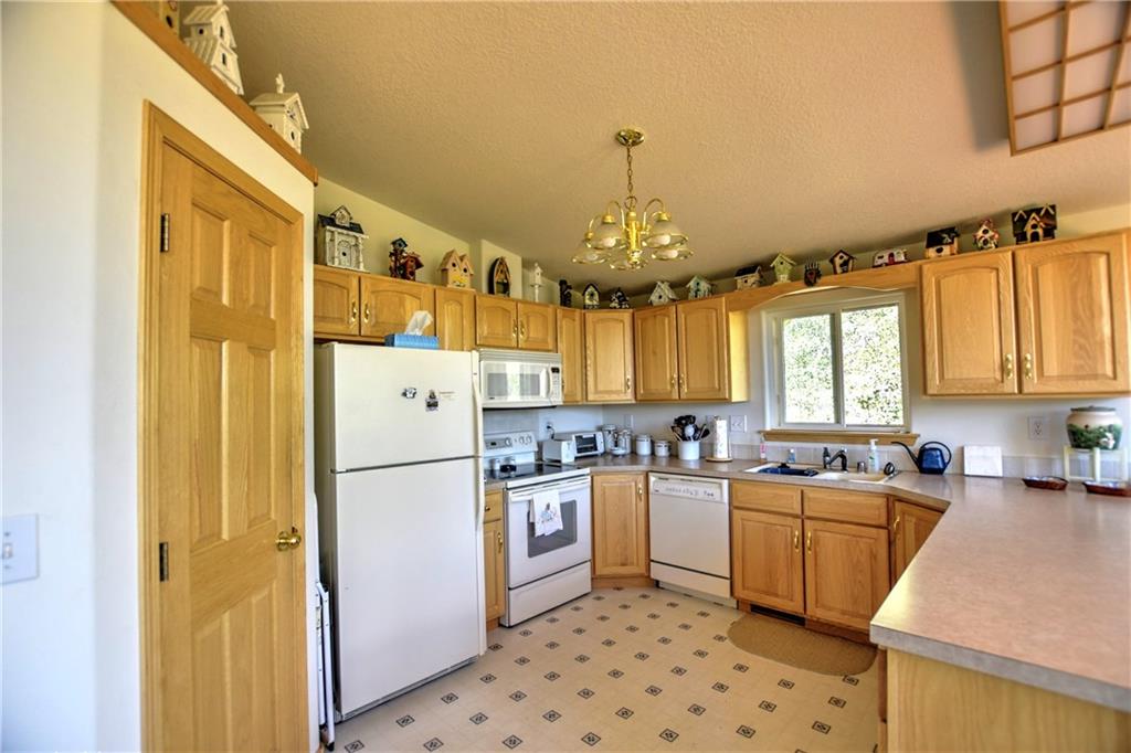 293 Old Squaw Road Como, CO 80432 - Photo 2 of 21 a kitchen with a sink a refrigerator and cabinets
