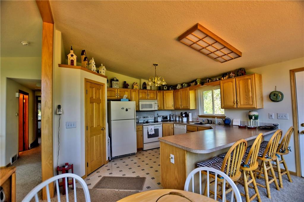 293 Old Squaw Road Como, CO 80432 - Photo 16 of 21 a kitchen with stainless steel appliances granite countertop a sink a stove and refrigerator