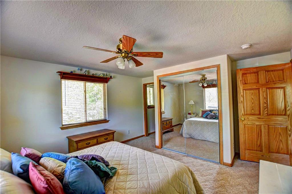 293 Old Squaw Road Como, CO 80432 - Photo 18 of 21 a bedroom with a bed and a chandelier