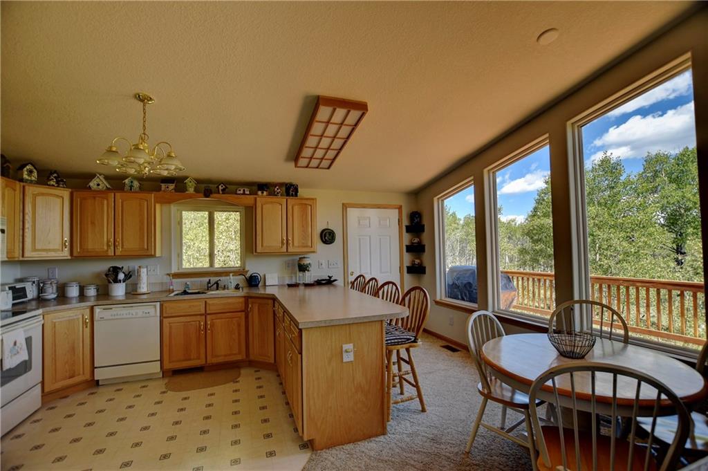 293 Old Squaw Road Como, CO 80432 - Photo 4 of 21 a kitchen with a table chairs stove and cabinets