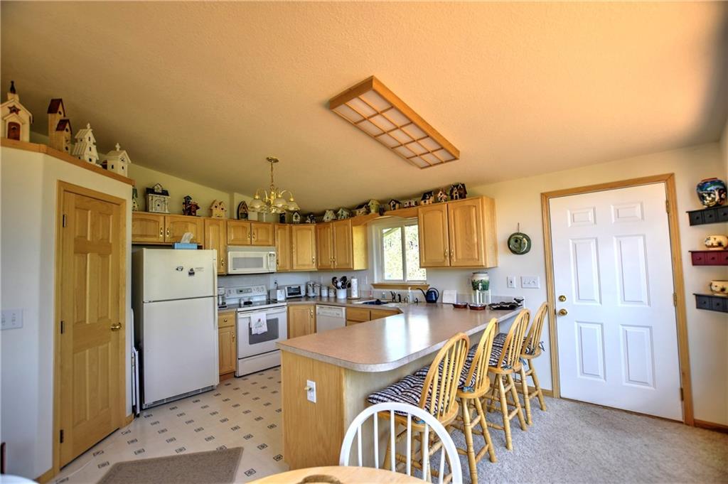 293 Old Squaw Road Como, CO 80432 - Photo 5 of 21 a kitchen with stainless steel appliances a dining table chairs and a refrigerator