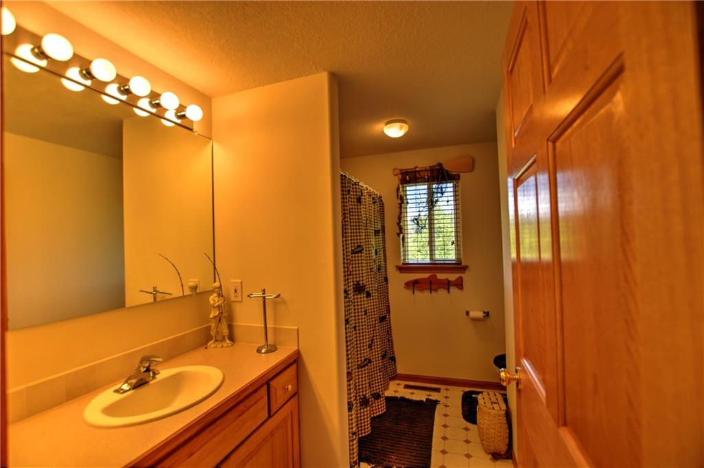 293 Old Squaw Road Como, CO 80432 - Photo 6 of 21 a bathroom with a sink mirror and shower