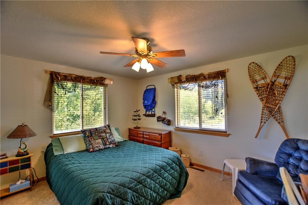 293 Old Squaw Road Como, CO 80432 - Photo 7 of 21 a bedroom with a bed and a chandelier