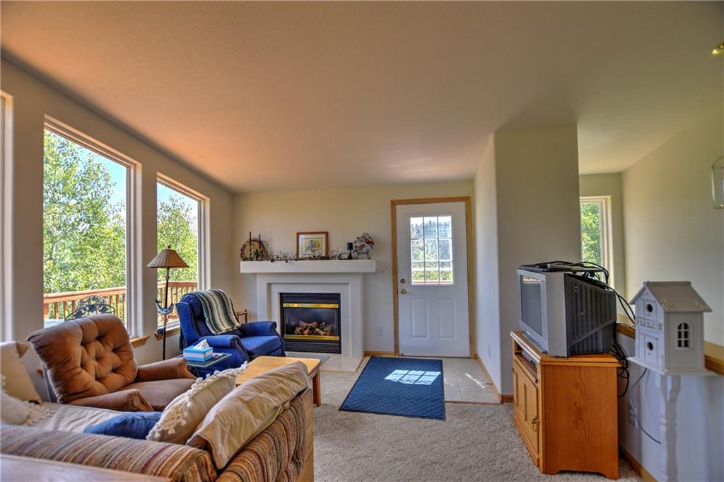 293 Old Squaw Road Como, CO 80432 - Photo 9 of 21 a living room with furniture fireplace and a large window