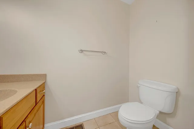 a white toilet sitting next to a shower