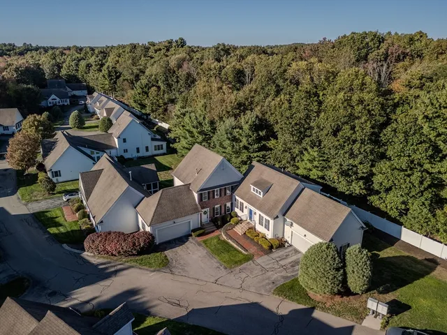 an aerial view of a house with a yard
