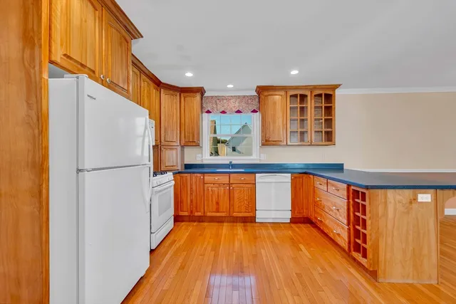 a kitchen with stainless steel appliances granite countertop a refrigerator and a sink