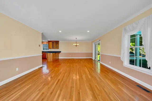 a view of a room with wooden floor