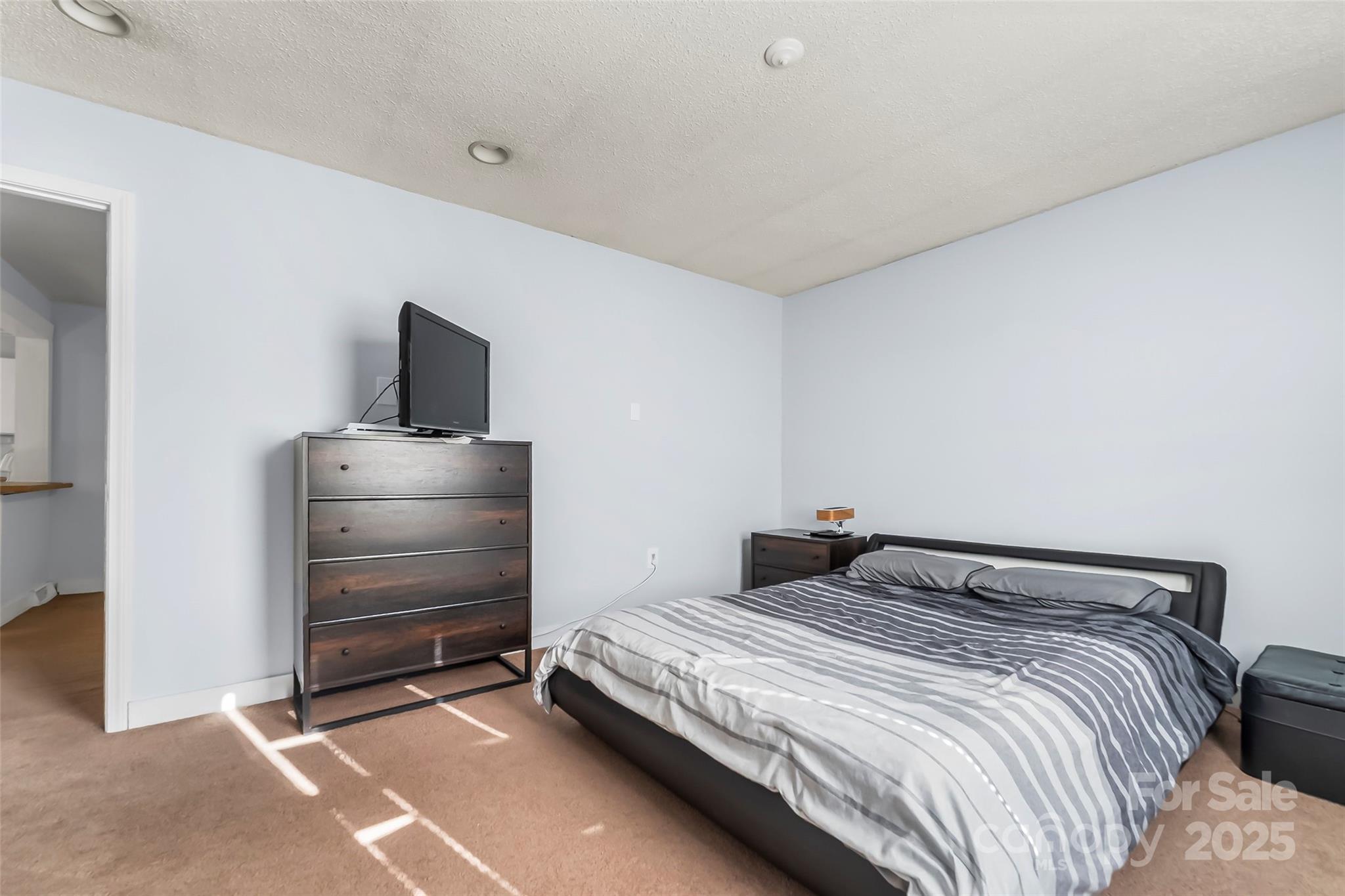 601 West 2nd Street Cherryville, NC 28021 - Photo 11 of 19 a bedroom with a bed and a television